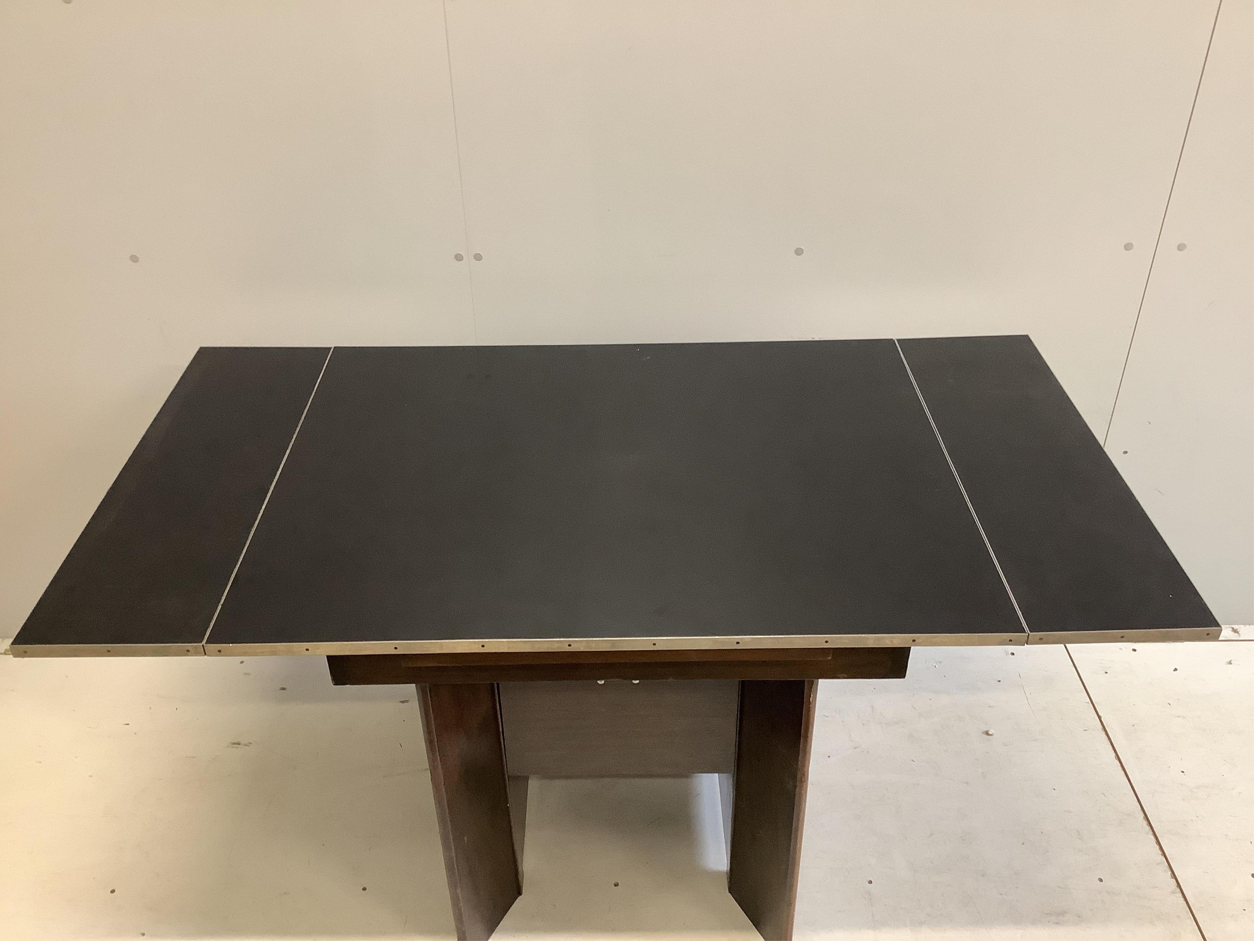 A mid century chrome mounted draw leaf extending dining table, width 145cm extended, depth 76cm, height 76cm. Condition - fair